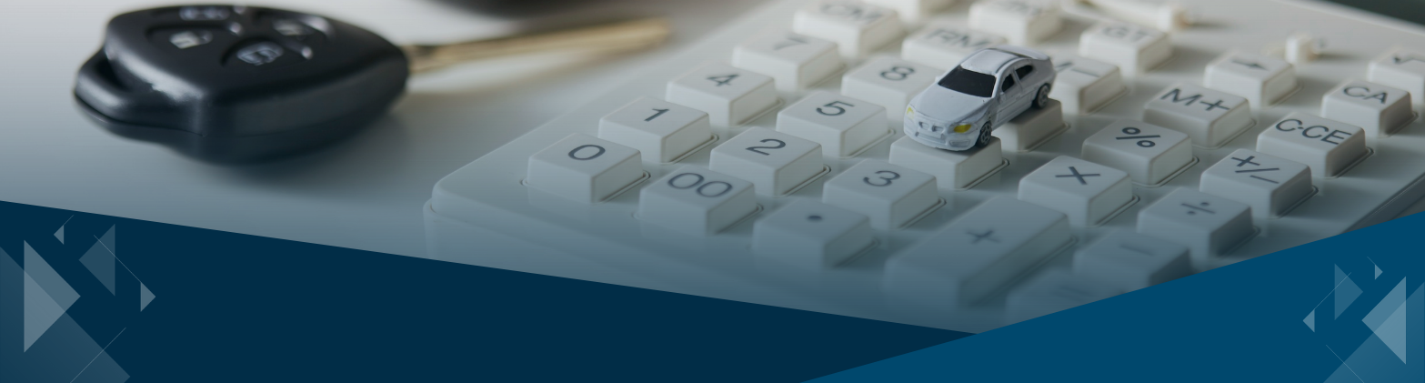 Business auto expense concept showing toy car and calculator on desk